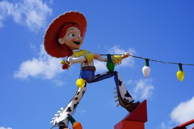 Jesse from Toy Story pulling on a string of Christmas lights