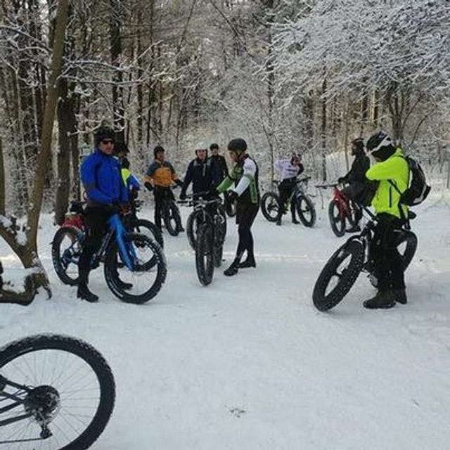 Group of people biking in winter